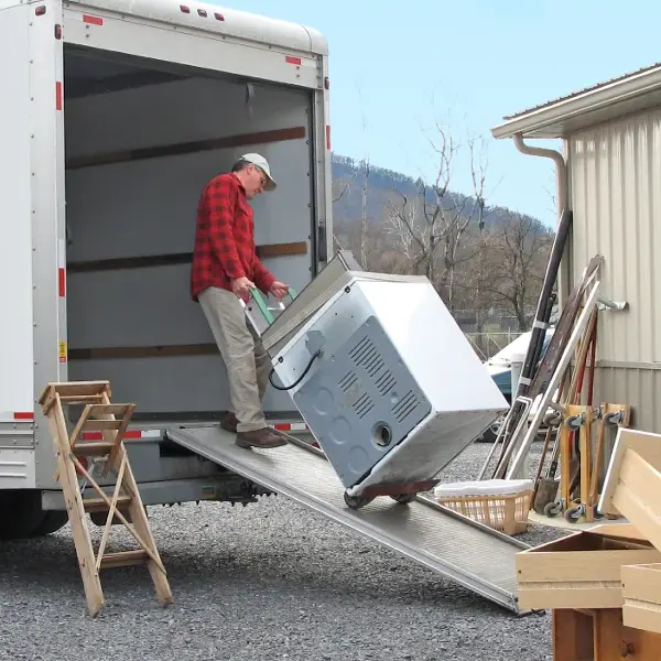 Man loading appliance into van