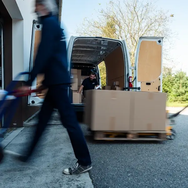 card board boxes being off loaded into a van